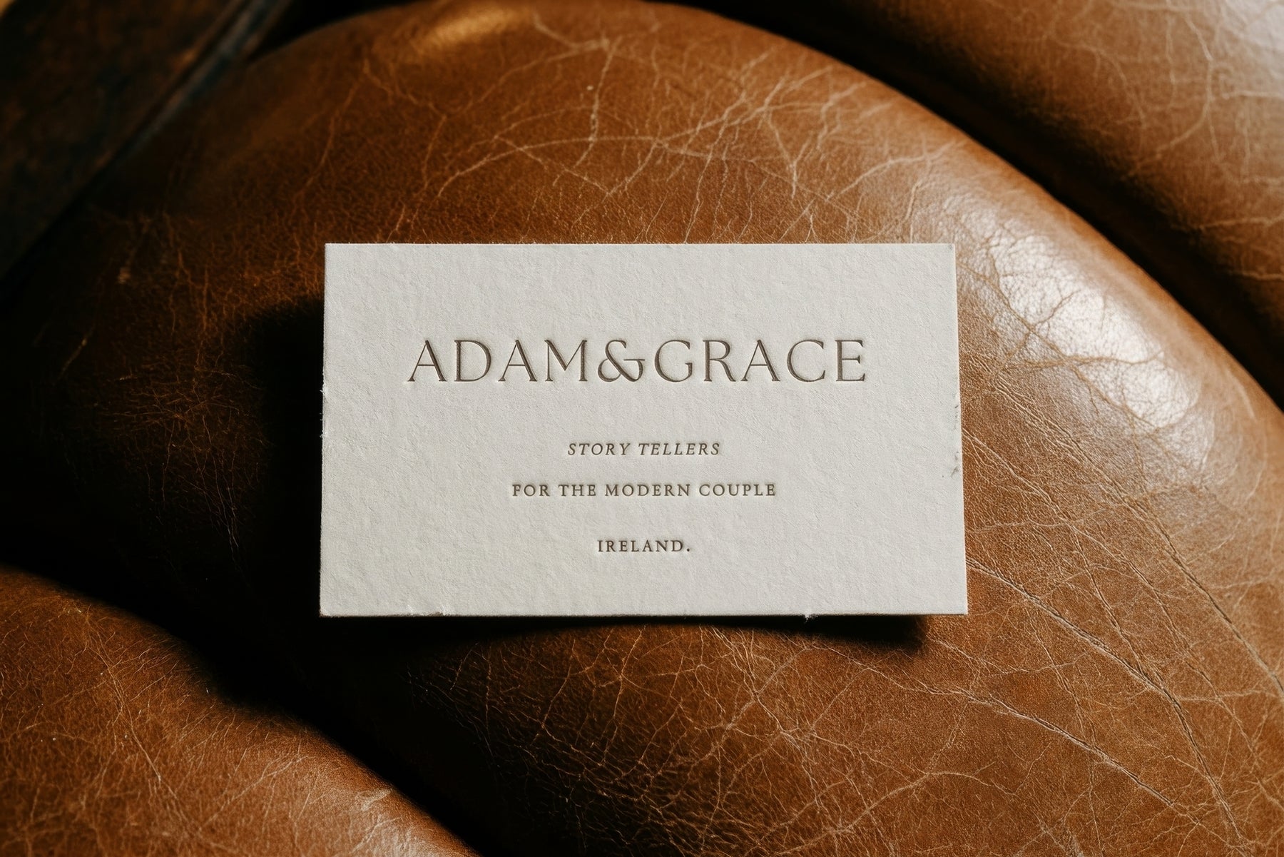 Adam and Grace business card on brown leather