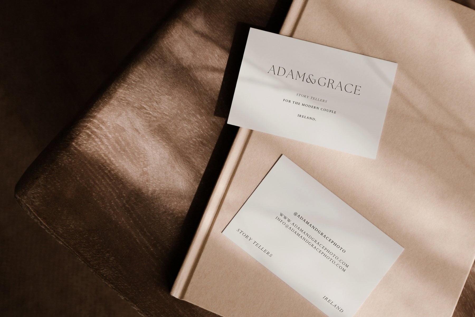 Business cards styled on a tan leather surface