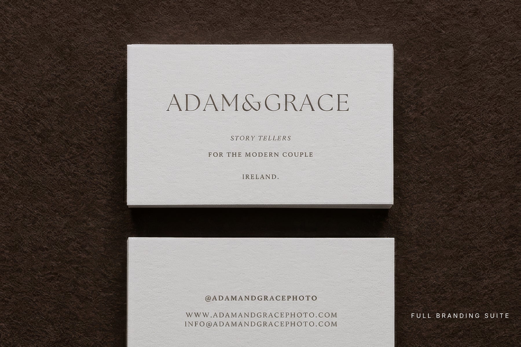 Adam and Grace business cards from the branding suite on a dark surface