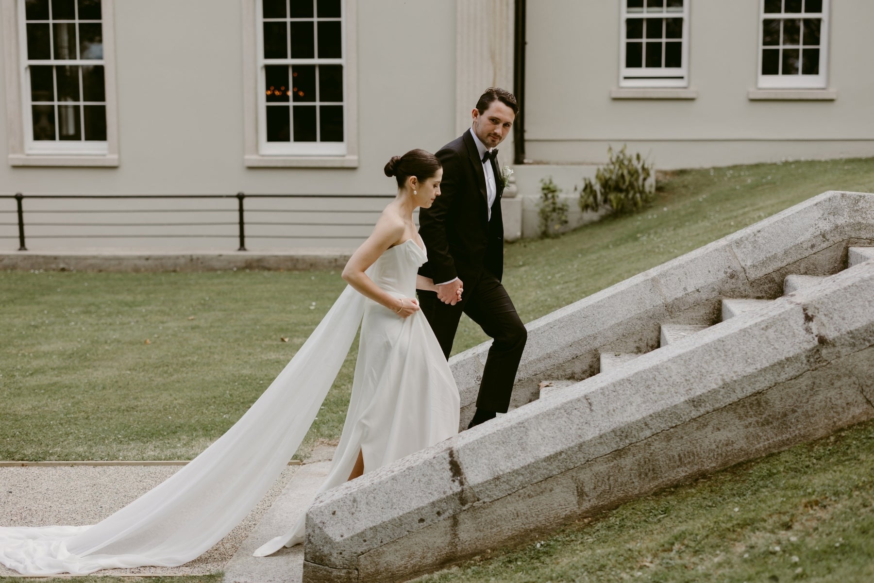 Bride and groom on the steps of a wedding venue