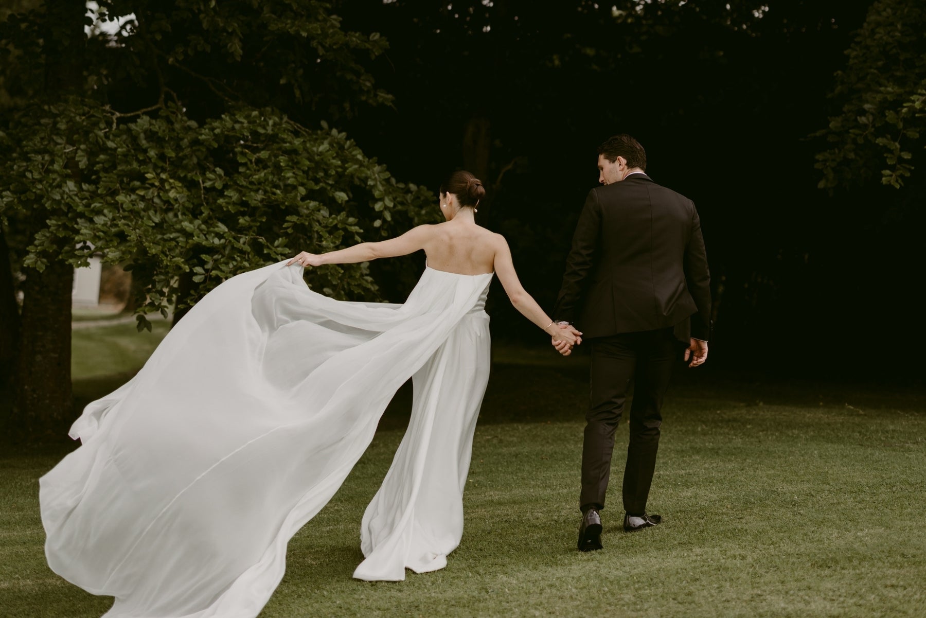 Bride twirling her dress with groom, candid wedding movement