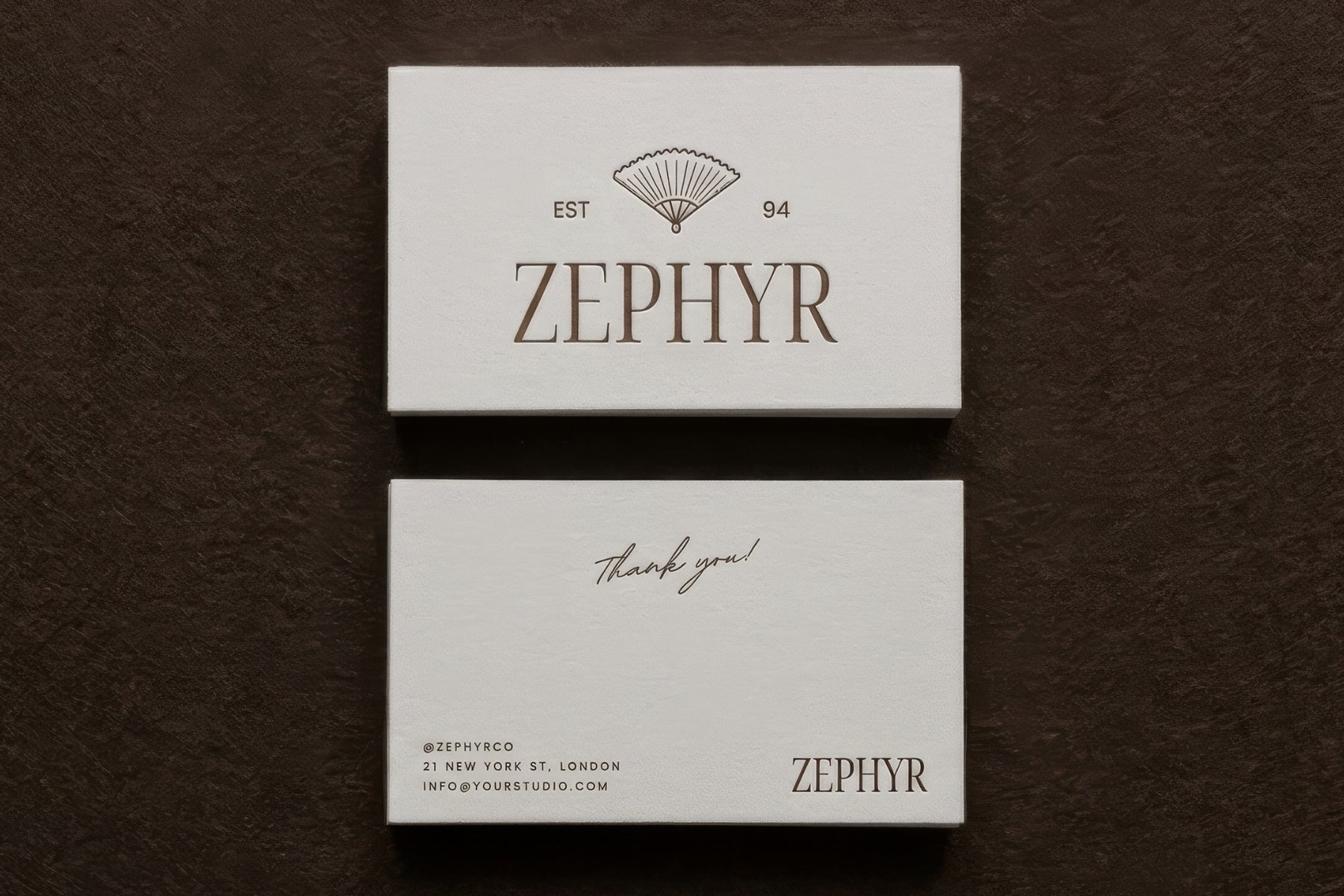 Zephyr business cards and thank-you card on a dark textured surface